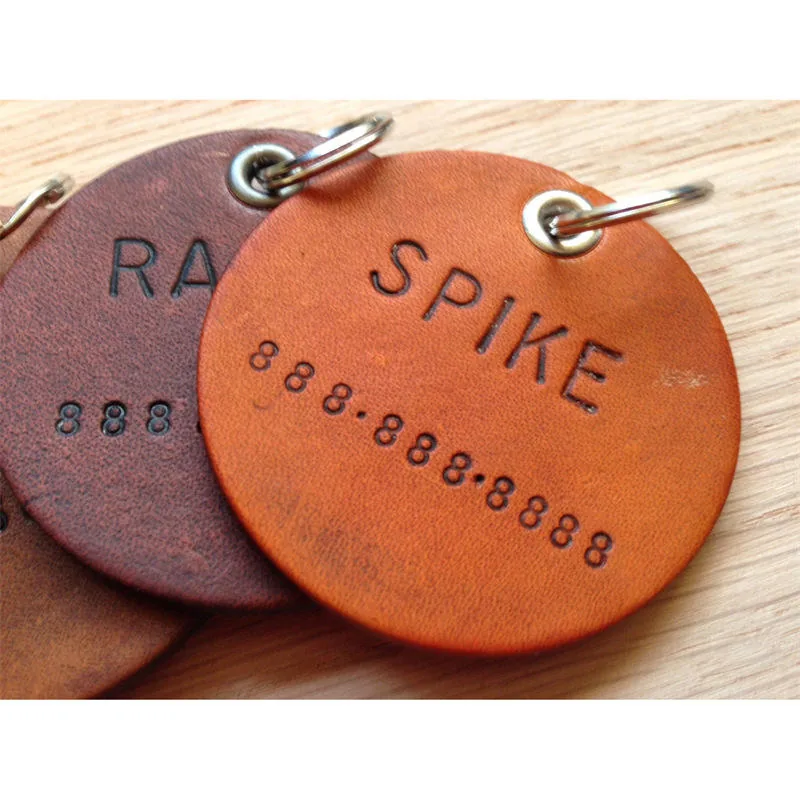 Close view of personalized lettering on leather pet tags