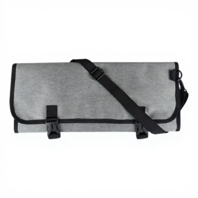 Folded grey chef tool bag with external securing straps