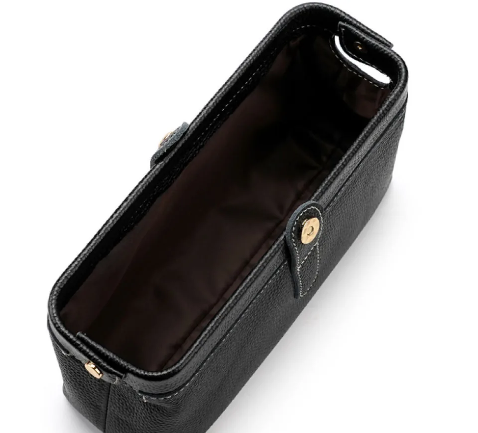 Open black leather toiletry bag showing its lining and zip