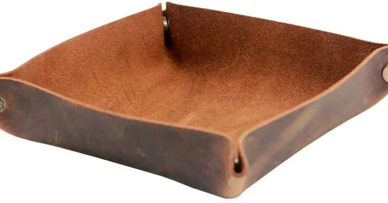 Empty brown leather bedside tray with snap-up corners