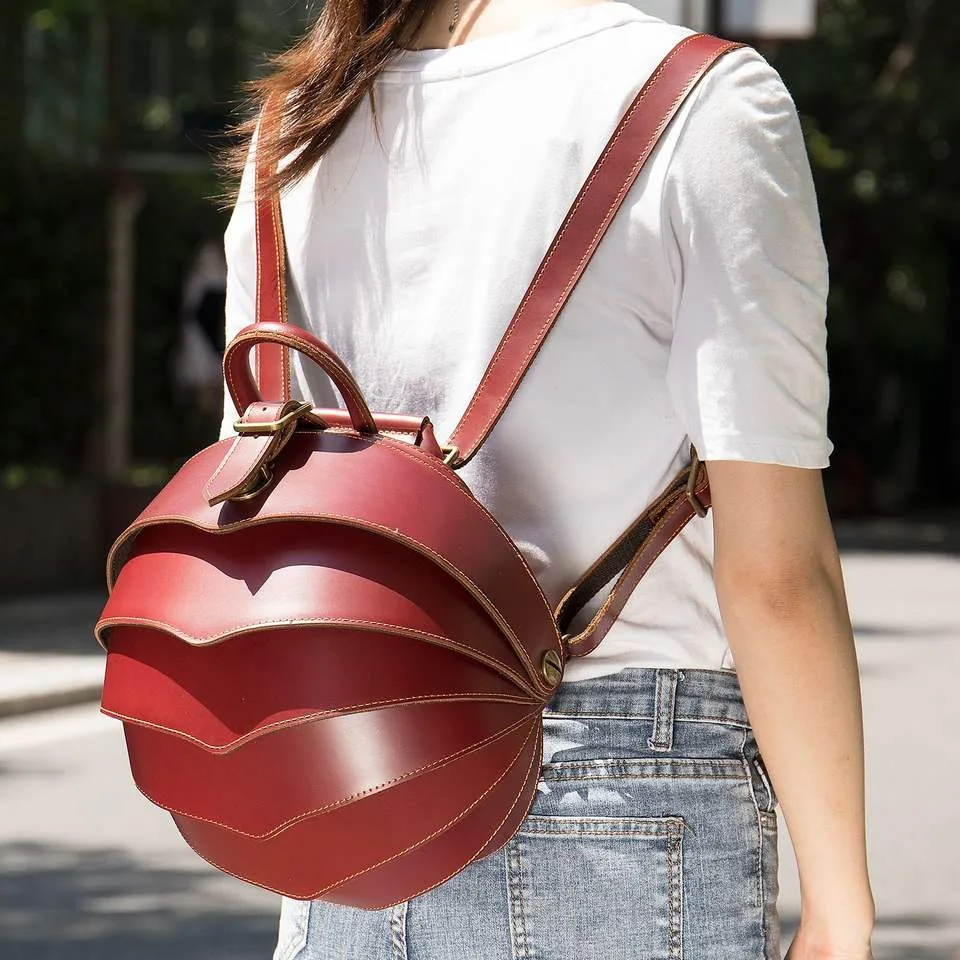 Red leather backpack worn on the shoulder